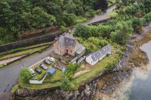 an aerial view of a house with cars parked in front at Stationmasters Lodge in Stromeferry