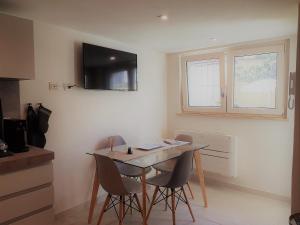 a kitchen with a table and chairs in a room at MINZONI94 - TwoBedroom+Garden in Lido di Camaiore