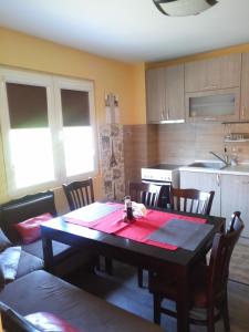 a living room with a table and a kitchen at Studio Lux in Pleven