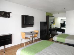 a hotel room with a bed and a table with chairs at Motel 6-Alexandria, LA - South in Alexandria