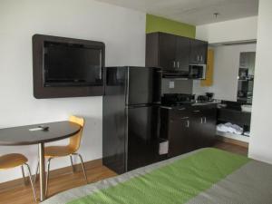 a kitchen with a black refrigerator and a table at Motel 6-Alexandria, LA - South in Alexandria