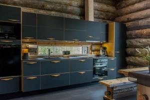 a kitchen with blue cabinets and a sink at Villa Konttaisenranta in Ruka