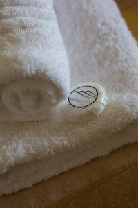 a stack of white towels with a sticker on them at Windfall Wine Farm in Robertson
