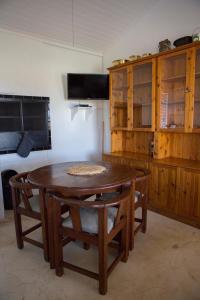 a kitchen with a wooden table and wooden cabinets at Windfall Wine Farm in Robertson