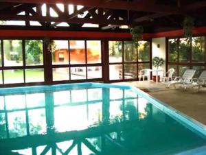 a large swimming pool in a house at FLAT - Residencial Pousada do Serrano in Gramado