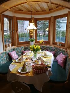 a dining room with a table with food on it at Landhaus Breitenberg in Bad Hofgastein