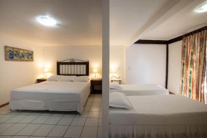 En eller flere senge i et værelse på Pousada Casa do Catavento