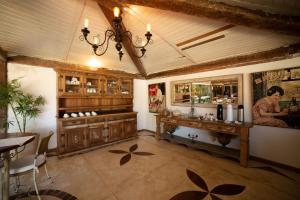 a kitchen with a table and a counter in a room at Pousada Casa do Catavento in Búzios +37 photos