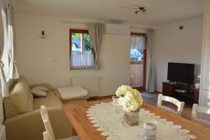 a living room with a table with flowers on it at Pr' Koritnek in Bled