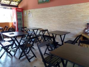 a row of tables and chairs in a restaurant at Aeropouso Pousada Executiva in Florianópolis