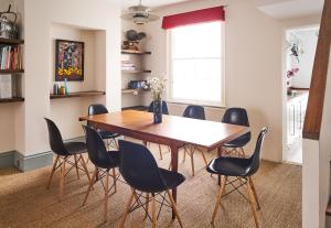 a dining room with a wooden table and chairs at Lovely 4 bed house 200m from the beach in Brighton & Hove