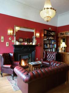 a living room with a couch and a fireplace at The Old Bank Bruff Townhouse in Bruff