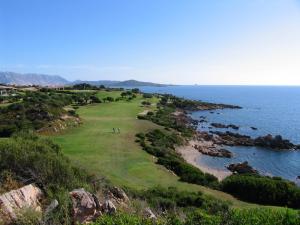 an aerial view of a golf course next to the ocean at Due Lune Puntaldia Resort & Golf in San Teodoro
