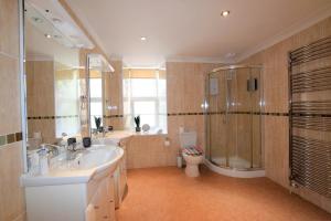 a bathroom with a sink and a shower and a toilet at Meridian Way - 3 Bed Apartment - Sleeps 7 in Bristol