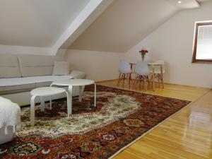 a living room with a couch and a rug at Apartman Đoković in Višegrad +10 photos