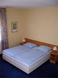 フレールスハイムにあるHotel Waldesruhのベッドルーム1室(大型ベッド1台、青いシーツ付)