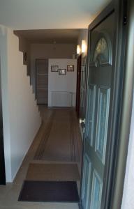 a hallway with a blue door and a staircase at Guest House Dimitrije in Niška Banja