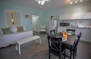 a kitchen and a living room with a table and a couch at Hollywood Beachside Boutique Suite in Hollywood