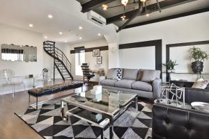 a living room with a couch and a table at Les Lofts du Mont Royal in Montréal