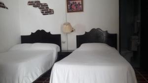 Postel nebo postele na pokoji v ubytování Hotel De Cortez y Larraz