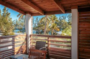 a balcony with a table and chairs and a view of the ocean at Cote Plage in La Saline les Bains