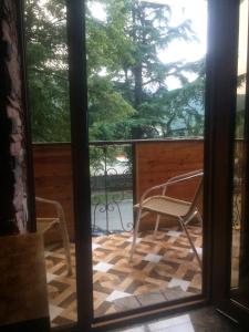 an open door to a patio with chairs on a porch at DILIJAN Apartment in Dilijan