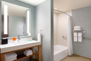 a bathroom with a shower, sink, and toilet at Hyatt Place Niagara Falls in Niagara Falls