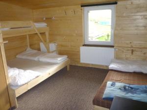 מיטה או מיטות בחדר ב-Chata Pod Kloboukem