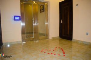 a bathroom with a shower with a red bow on the floor at Pentagon Hotel and Suites in Umueme