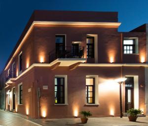 an exterior view of a building at night at Intra Muros Hostel in Heraklio