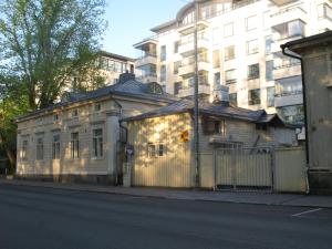 a building on the side of a street next to a building at Uniikki talo kirjastosilta - Unique house at centre in Turku