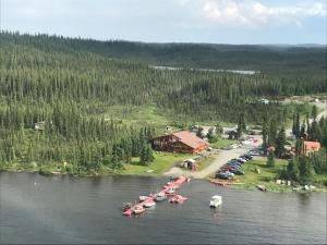 an aerial view of a resort with boats in the water at Lake Louise Lodge, Alaska in Glennallen