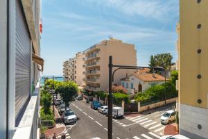 a view of a street with parked cars and buildings at Beautiful studio near sea (free parking) in Roquebrune-Cap-Martin