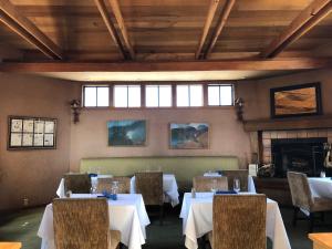a dining room with tables and chairs and a fireplace at Mountain Home Inn in Mill Valley