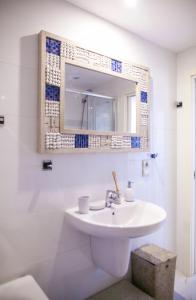 a bathroom with a sink and a mirror at Duquesa Seaview marina in Manilva