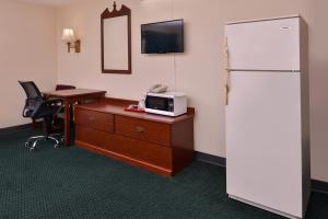 a kitchen with a refrigerator and a microwave at Red Carpet Inn in Worthington