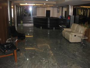 a lobby with a couch and chairs and a piano at Hotel Florida in Albacete