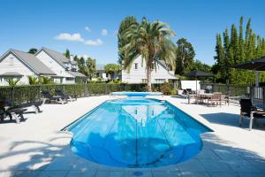 a swimming pool with blue water in a yard at Settler's Cottage - Russell Cottages Collection in Russell