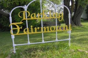 a sign that says parkland rainforest in front of a bench at Fairmount Bed & Breakfast in Basswood