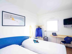 Postel nebo postele na pokoji v ubytování ibis Budget Pouilly-en-Auxois