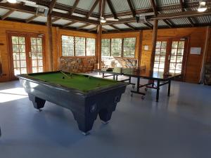 a large room with two pool tables in it at Bundera Lodge in Vacy