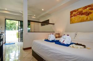 a bedroom with a bed with two elephants on it at Phuket Riviera Villas Hotel in Nai Harn Beach +91 photos
