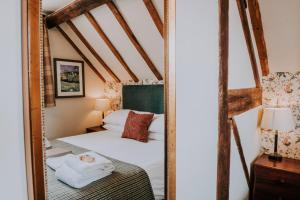 um reflexo de espelho de uma cama num quarto em The Stag Rooms em Stratford-upon-Avon