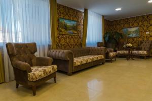a living room with couches and chairs in a room at Baku Hotel in Astrakhan
