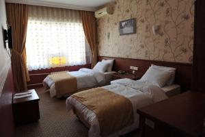 Postel nebo postele na pokoji v ubytování Saray Hotel