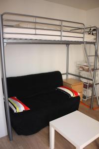 czarna kanapa w pokoju z łóżkiem piętrowym w obiekcie Studio Dijon entre fac hopital et centre w mieście Dijon