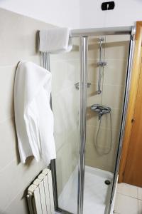 a bathroom with a shower with a glass door at Hotel Meranda in Camigliatello Silano