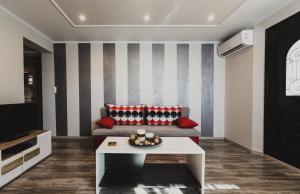 a living room with a couch and a table at Lenti Street House in Kallirákhi