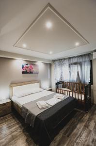 a bedroom with a large bed in a room at Lenti Street House in Kallirákhi