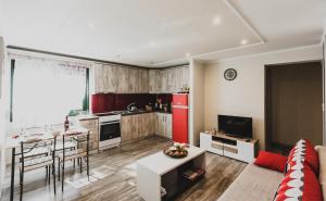 a kitchen with a red refrigerator and a living room at Lenti Street House in Kallirákhi